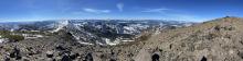 View from Mount Houghton looking West.  Bare foreground on S facing terrain and snow covered N aspects in the background.
