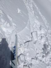 A ski kick caused this previously undercut wind-loaded test slope to crack. Slopes that had not been undercut did not crack. 