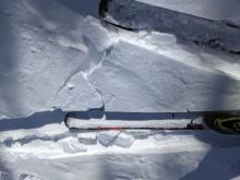 Minor cracking in an area of shallow wind drifted snow.