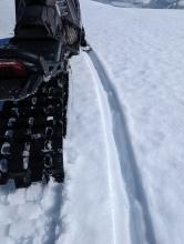 Ski and track penetration were a few inches into wet surface snow, with deeper boot penetration 
